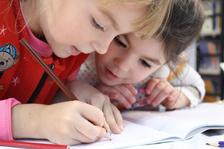 children studying writing together classroom